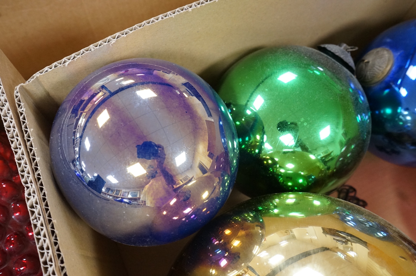A collection of coloured circular and grape shaped glass witches balls and decorations, largest grape decoration 40cm in length